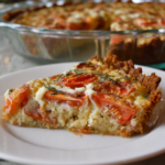 Served slice of Crumb Topped Four Cheese Tomato Pie with garnish