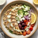 High protein Mediterranean lemon-dill chicken bowl with fresh herbs and vegetables