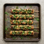 Grilled chimichurri chicken garnished with fresh herbs and spices