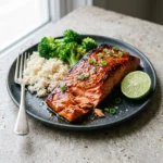 Baked Bang Bang Salmon served with a vibrant sauce and garnished with herbs