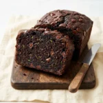 Fudgy chocolate zucchini bread slices on a plate.