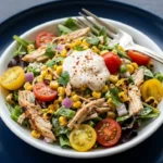 Creamy high protein chicken salad with street corn served in a bowl.