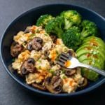 Creamy keto breakfast plate with eggs, avocado, and vegetables for a healthy start.