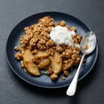 Delicious healthy breakfast apple crumble topped with oats and cinnamon