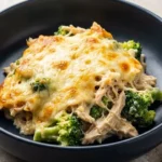 Keto Chicken Broccoli Casserole topped with creamy Alfredo sauce