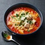 One-pot chicken orzo tomato soup served in a bowl